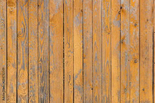 Close-up of a   brown wooden  wall  painted a very long time and the paint peeled off.  Brown texture background © Виталий Сова