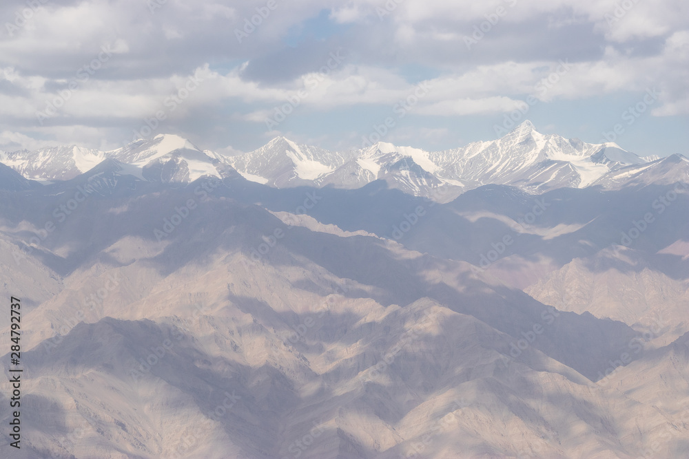 View of the Himalayas mountain through airplane window.