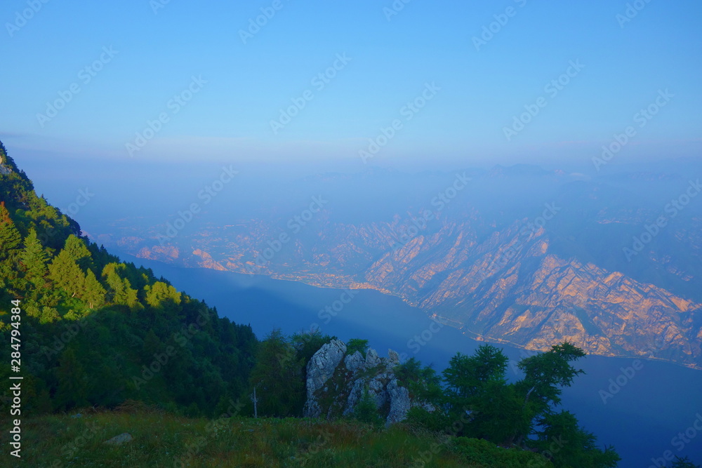 Obraz premium Sunrise from the top of Lago di Garda - beautiful emerald alpine lake located in the north of Italy, South Tyrol