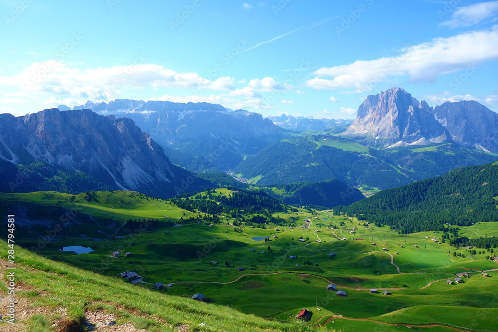 Hiking trail leading around peaks of picturesque Seceda Alpine meadows during summer, Ortisei, Dolomites, Northern Italy, Tyrol