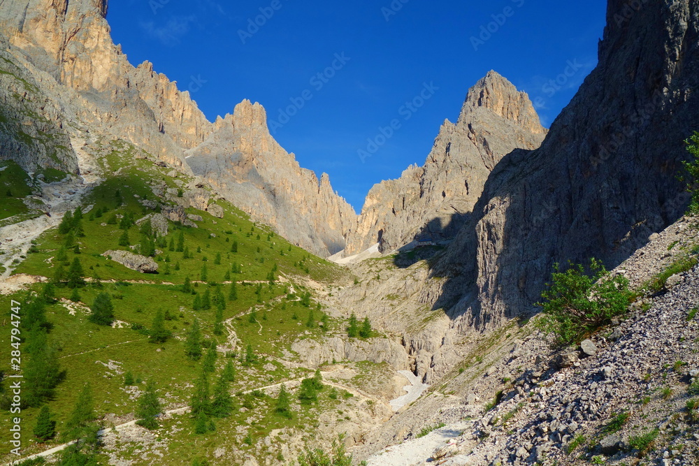 Rocky valley of Passo Sella in the Dolomites during summer with Passo Gardena right behing, Tyrol, Italy Rocky valley of Passo Sella in the Dolomites during summer with Passo Gardena right behing, Tyrol, Italy