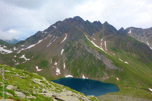 Fototapeta Naklejka Na Ścianę i Meble -  Mountain lake Eisbruggsee on a hiking trail leading to Edelrauthütte in Dolomites, South Tyrol, Italy