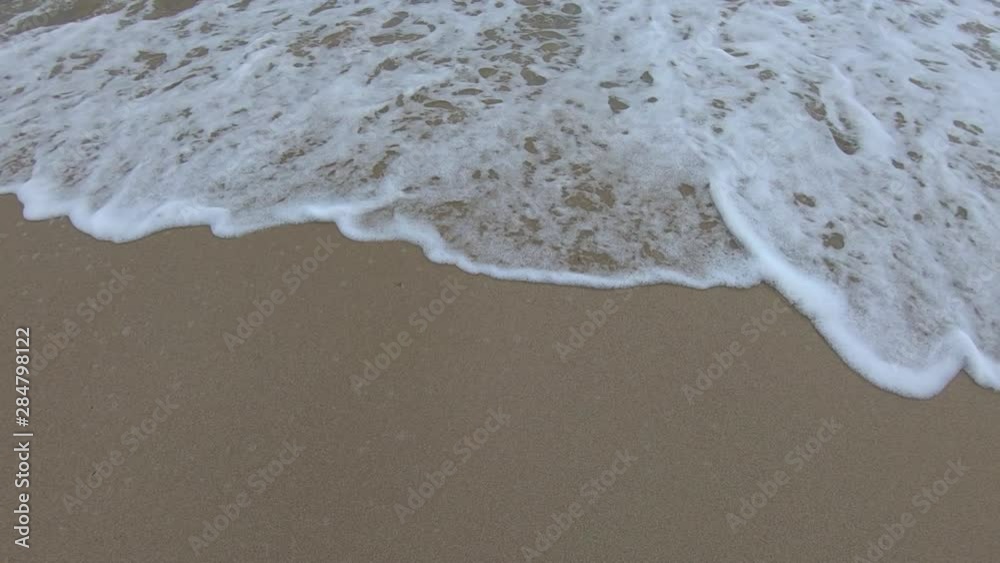 Close up tidal waves hitting fine sand Atlantic shore, Miami Beach, Florida Close up tidal waves hitting fine sand Atlantic shore, Miami Beach, Florida