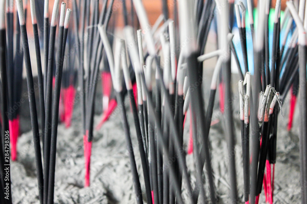 Incense at the point in the temple, Incense sticks in a large pot, Burning incense in the temple. Respect and praying. Buddhist temple. Incense at the point in the temple, Incense sticks in a large pot, Burning incense in the temple. Respect and praying. Buddhist temple.
