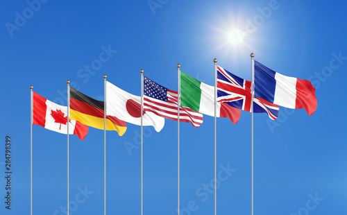 Big Seven. G7 flags Silk waving flags of countries of Group of Seven Canada, Germany, Italy, France, Japan, USA states, United Kingdom 2019. Blue sky background. 3D illustration.