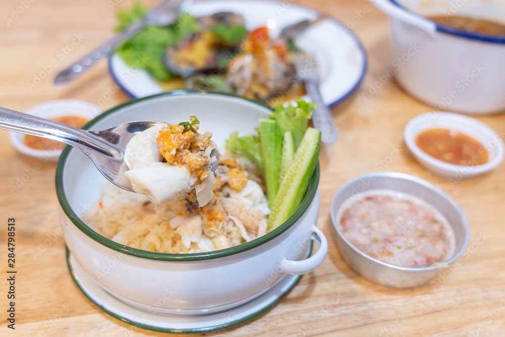 White rice mix crab and Crab's spawn seafood with cucumber in Food carrier on wooden table background.