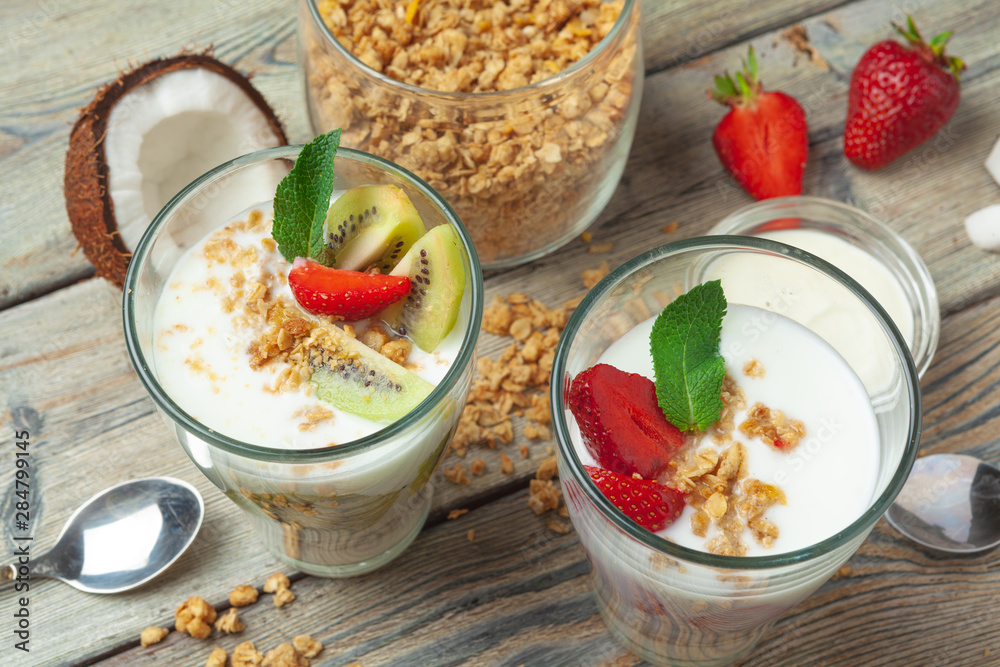 Healthy breakfast with yogurt, berries and granola on wooden table top view Healthy breakfast with yogurt, berries and granola on wooden table top view