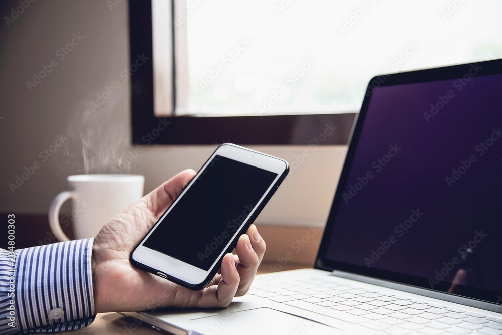 Fototapeta premium Businessman working with computer with coffee cup in the hotel room - people working lifestyle concept