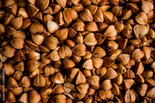 The texture of dry buckwheat. Background image of buckwheat porridge. Maro's Photo