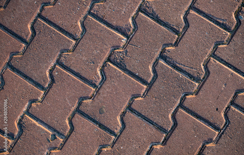 Texture of paving slabs overgrown with grass. Background image of a stratum stone