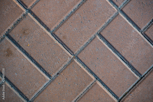 Texture of paving slabs overgrown with grass. Background image of a stratum stone