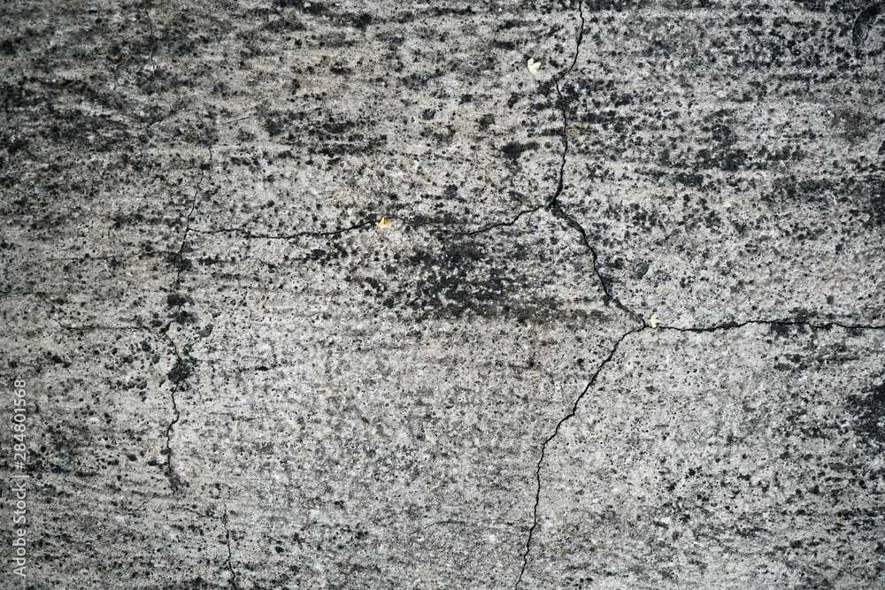 Obraz premium Texture of an old cracked concrete wall. Background image of a worn gray concrete surface