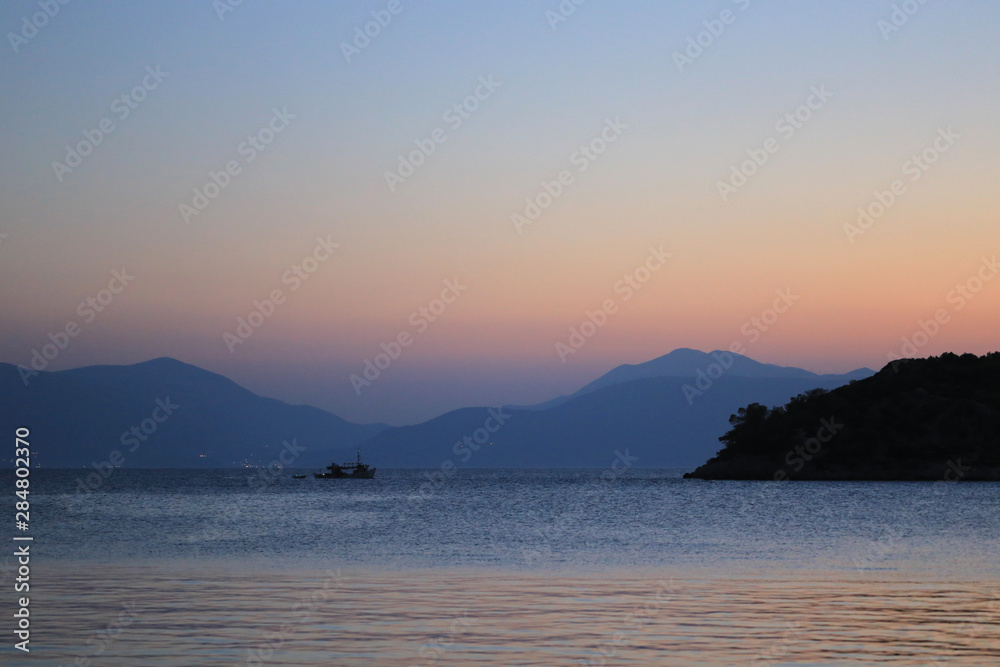 Panoramic view sea and mountains after sunset