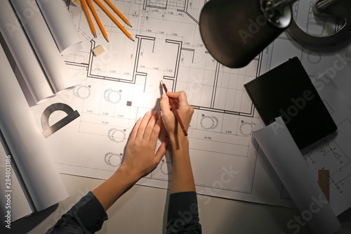 Female architect working la...