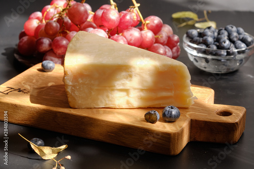 Parmigiano Cheese on  wooden cut board photo