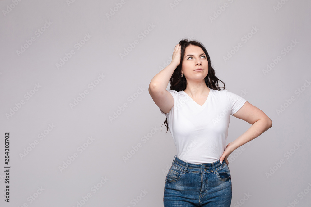 Portrait of happy fashion female with nice hairstyle and beautiful blue eyes posing at studio. Cheerful girl looking away and smiling. Isolated Portrait of happy fashion female with nice hairstyle and beautiful blue eyes posing at studio. Cheerful girl looking away and smiling. Isolated