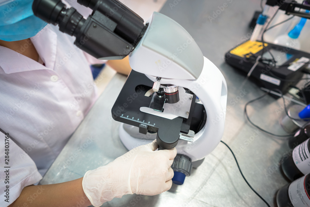 Asian technician tests the quality of product in laboratory closeup Asian technician tests the quality of product in laboratory closeup