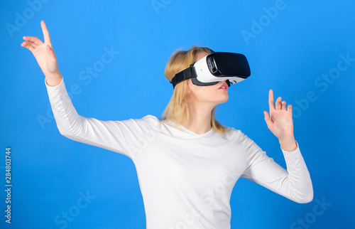Woman watching virtual reality vision. Excited smiling businesswoman wearing virtual reality glasses. Young woman using a virtual reality headset. Futuristic vision concept.