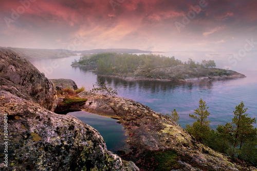 Evening landscape, Skhera Stone Islands in Lake Ladoga in the Republic of Karelia in Russia at sunset. Rock on the island of Koyonsaari photo