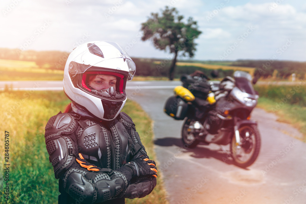 Girl driver portrait, protective equipment, turtle. body armor jacket. Adventure motorbike with bags. a motorcycle tour journey. light warm tinting, glow, freedom concept. safety first, safe driving Girl driver portrait, protective equipment, turtle. body armor jacket. Adventure motorbike with bags. a motorcycle tour journey. light warm tinting, glow, freedom concept. safety first, safe driving