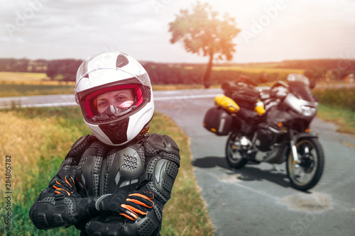 Girl driver portrait, protective equipment, turtle. body armor jacket. Adventure motorbike with bags. a motorcycle tour journey. light warm tinting, glow, freedom concept. safety first, safe driving