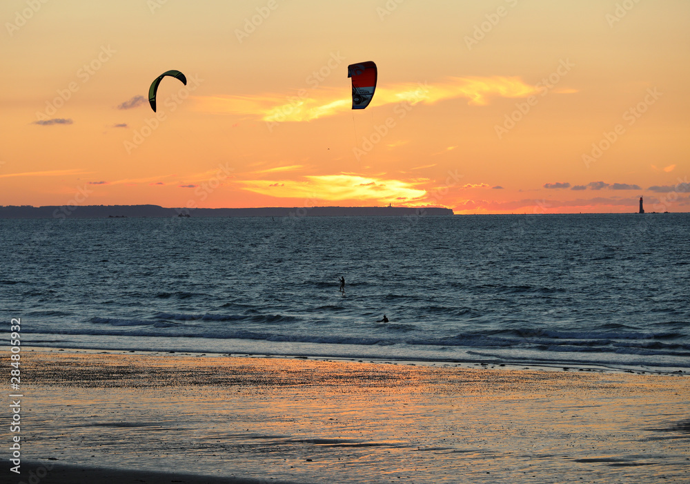 Sunset and Kitesurfers on the beach in Saint Malo, Brittany, France Sunset and Kitesurfers on the beach in Saint Malo, Brittany, France