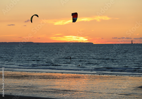  Sunset and Kitesurfers on the beach in Saint Malo, Brittany, France