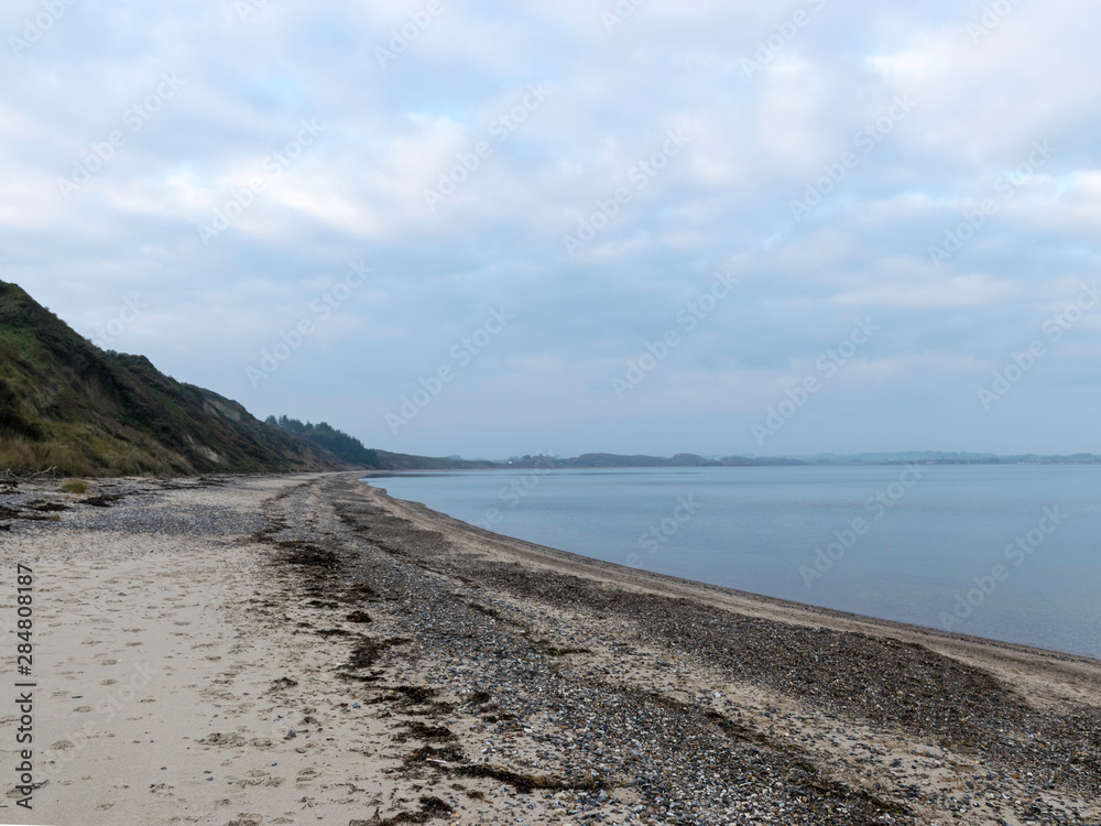 landscape with steep North Sea coast, cloudy day, gray sky