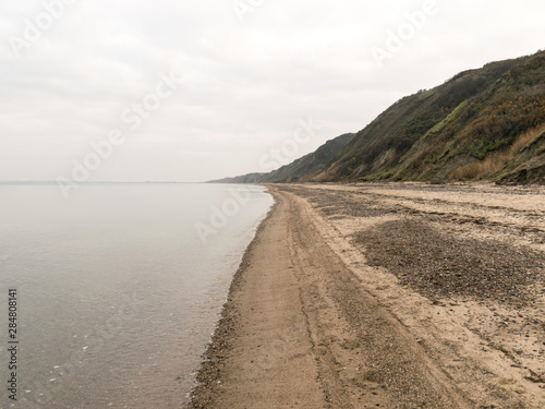 landscape with steep North Sea coast  cloudy day  gray sky