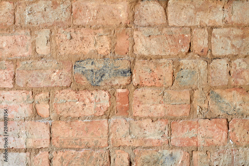 Background of old red vintage brick wall. Background of brick wall texture. Closeup