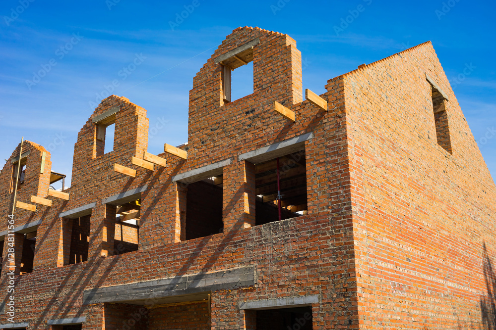 Unfinished house of brick, still under construction before installing the roof and windows. Unfinished house of brick, still under construction before installing the roof and windows.