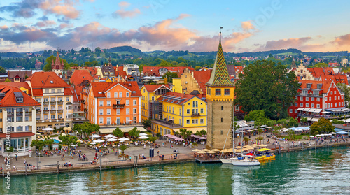 Lindau  Germany. Antique Bavarian town in Bavaria at coastline of Lake Constance  Bodensee . Habour along embankment with traditional houses and tower. Sunset evening landscape.
