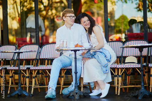 Happy romantic couple in Paris, drinking coffee