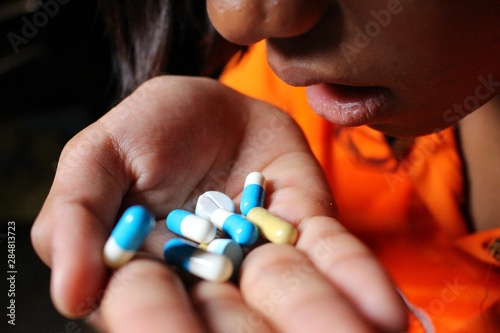 Young women are taking drugs, sitting in low light