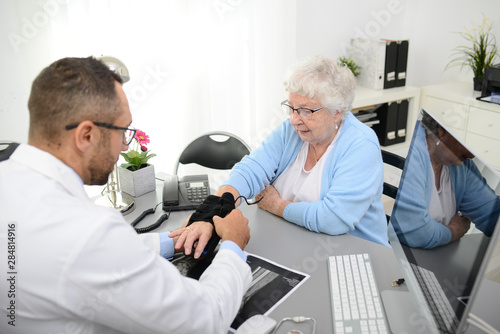 elderly senior woman having a medical consultation with her doctor in office diagnostic