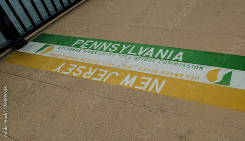 Fotografie Sign on the floor indicating the border between New Jersey and Pennsylvania, New