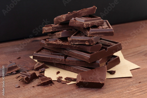 Photography heap of broken pieces of dark bitter chocolate