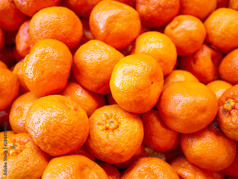 Bunch of fresh oranges mandarins for sale in the market close up top view Bunch of fresh oranges mandarins for sale in the market close up top view
