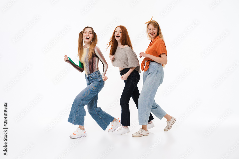 Portrait of three gorgeous girls wearing casual clothes smiling and having fun together Portrait of three gorgeous girls wearing casual clothes smiling and having fun together