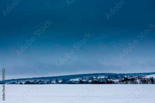 Winter landscape with snowy field and dark blue sky_ © Volodymyr