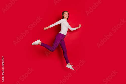 Full length body size photo of girl running away from her problems while isolated with red background