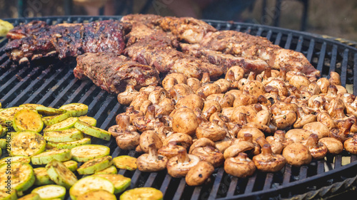 Grilling meat, zucchini and mushrooms. Delicious food for tourists_