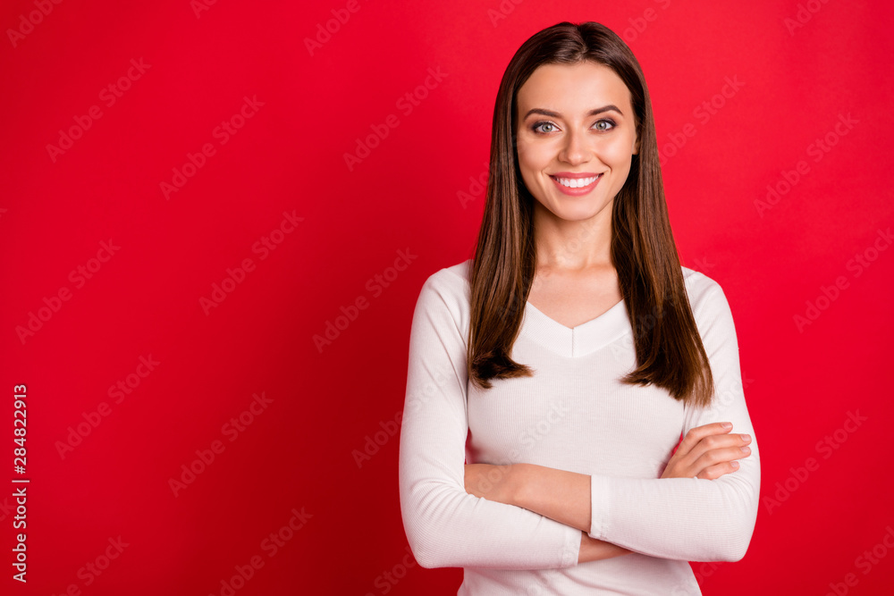 Photo of beautiful cheerful enjoying woman enjoying her life and giving you her smile while isolated with red background
