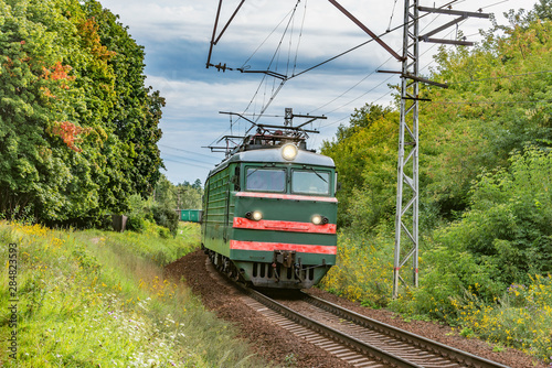 Freight train moves on the countryside background.