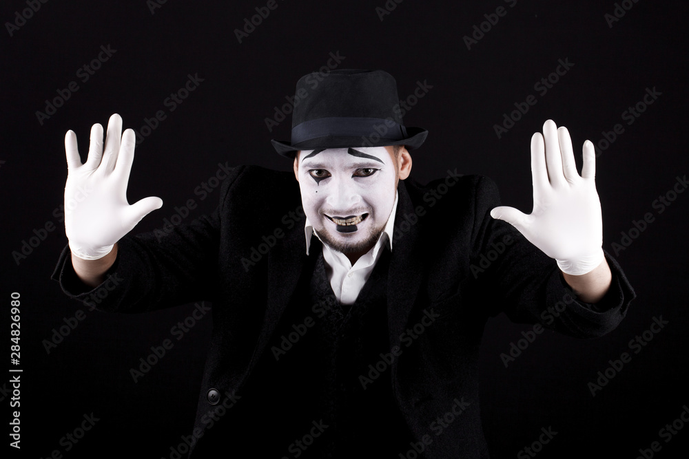 mime shows theatrical emotions on black background
