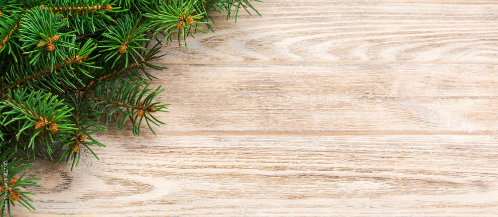 Christmas gray wooden background with fir tree and copy space. banner top view empty space for your design Christmas gray wooden background with fir tree and copy space. banner top view empty space for your design