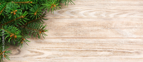 Christmas gray wooden background with fir tree and copy space. banner top view empty space for your design
