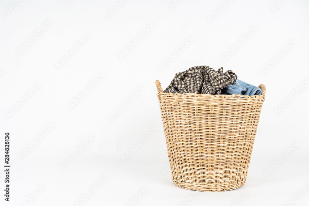 Obraz premium Wicker basket of clothes isolated on white background
