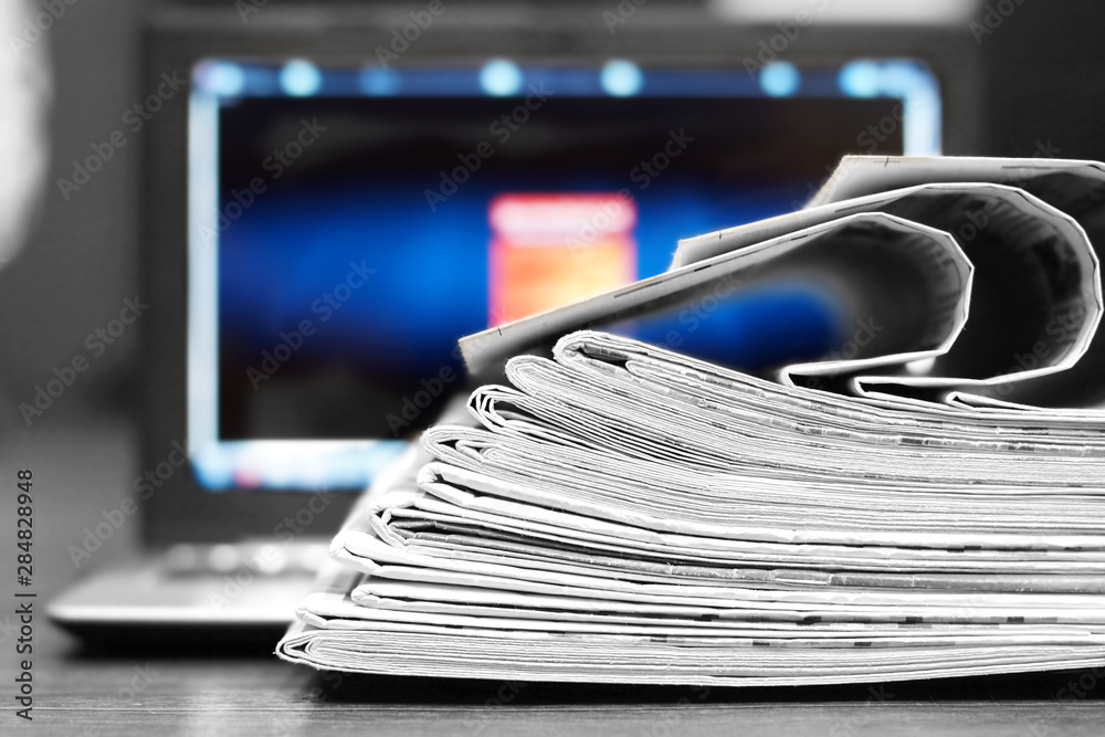 Newspapers and Laptop. Magazines Stacked on Computer. Tabloid Journals and Open Notebook - Information and News on Paper Pages or on Device Screen by Internet Newspapers and Laptop. Magazines Stacked on Computer. Tabloid Journals and Open Notebook - Information and News on Paper Pages or on Device Screen by Internet
