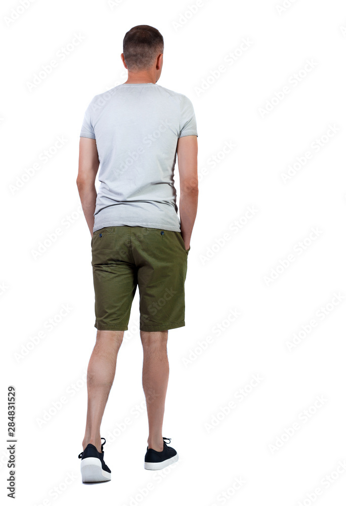 Back view of going handsome man in shorts. Back view of going handsome man in shorts.